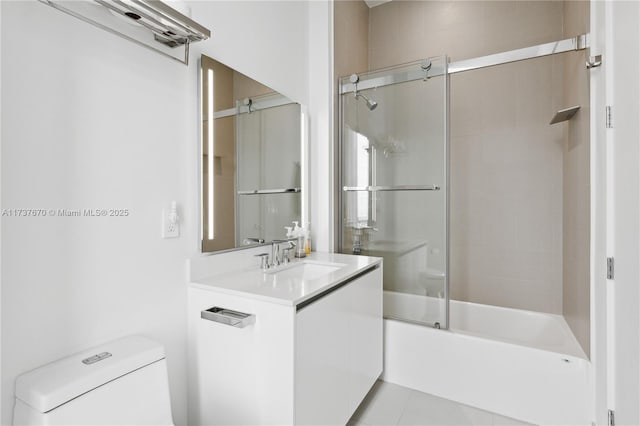 full bathroom featuring vanity, toilet, tile patterned flooring, and combined bath / shower with glass door