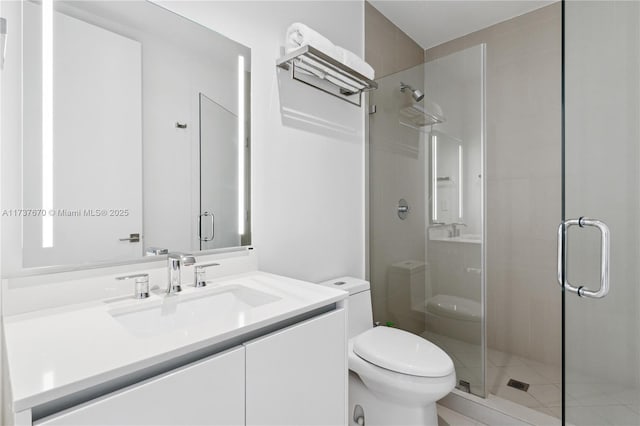 bathroom with vanity, an enclosed shower, and toilet