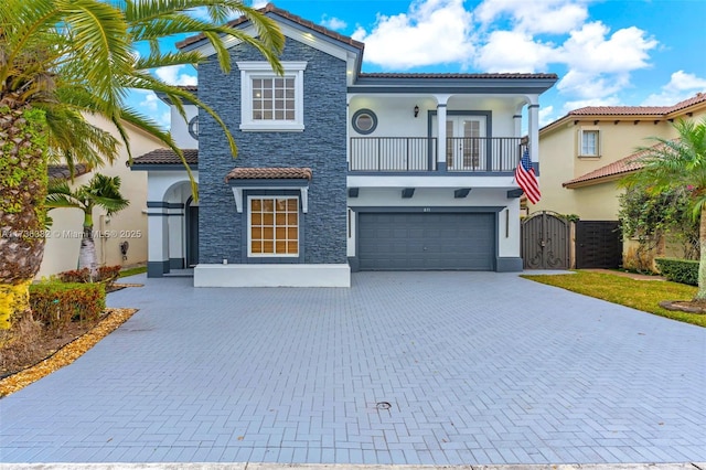 mediterranean / spanish-style home with a balcony and a garage