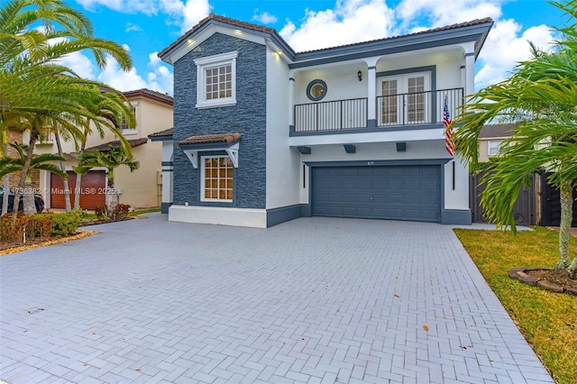 mediterranean / spanish-style house with a garage and a balcony