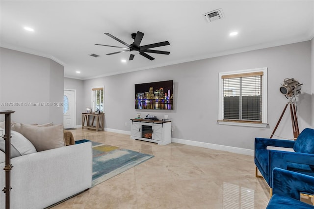 living room with ornamental molding and ceiling fan