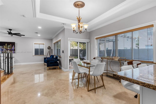 dining space featuring ceiling fan with notable chandelier, ornamental molding, and a raised ceiling