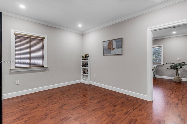 spare room with crown molding and dark hardwood / wood-style floors