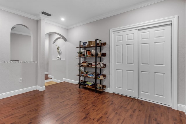 foyer featuring ornamental molding and dark hardwood / wood-style flooring