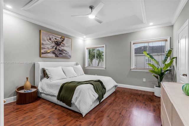 bedroom with ceiling fan, ornamental molding, dark hardwood / wood-style flooring, and a tray ceiling