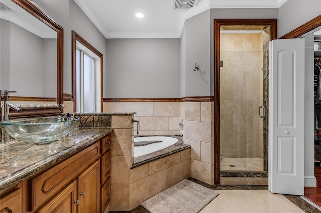 bathroom with crown molding, vanity, and independent shower and bath