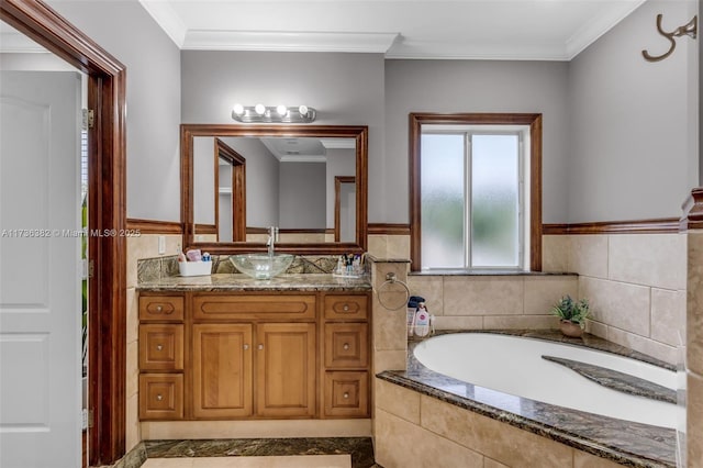 bathroom featuring a relaxing tiled tub, vanity, and crown molding