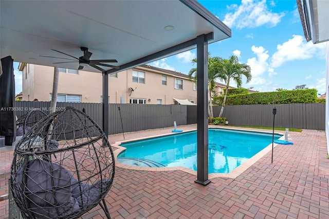 view of pool with ceiling fan and a patio