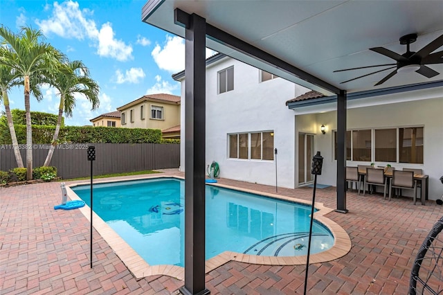 view of pool with a bar, a patio, and ceiling fan