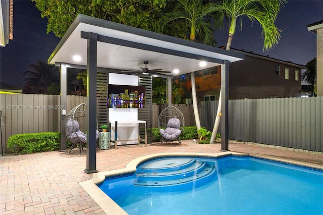 view of pool with ceiling fan and a patio