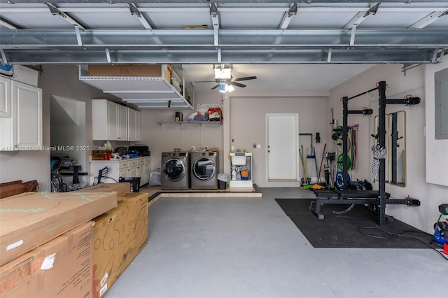 garage featuring electric panel and independent washer and dryer