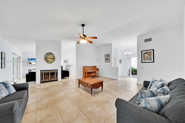 tiled living room with ceiling fan with notable chandelier, vaulted ceiling, and a textured ceiling