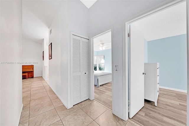 corridor with light hardwood / wood-style flooring