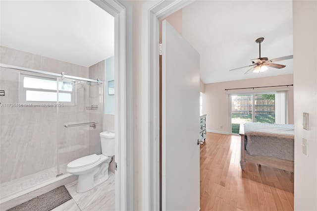 bathroom with wood-type flooring, lofted ceiling, ceiling fan, toilet, and a shower with door