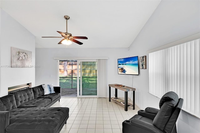 living room featuring lofted ceiling, light tile patterned floors, and ceiling fan