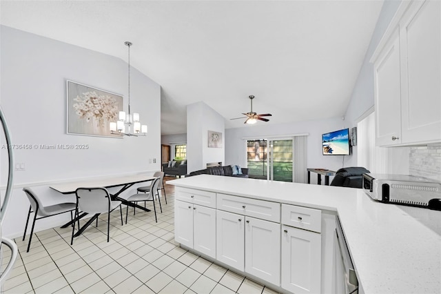 kitchen featuring pendant lighting, ceiling fan with notable chandelier, vaulted ceiling, and white cabinets