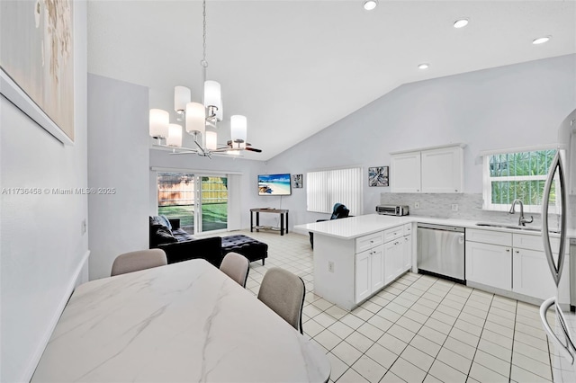 kitchen featuring sink, white cabinetry, decorative light fixtures, kitchen peninsula, and stainless steel appliances