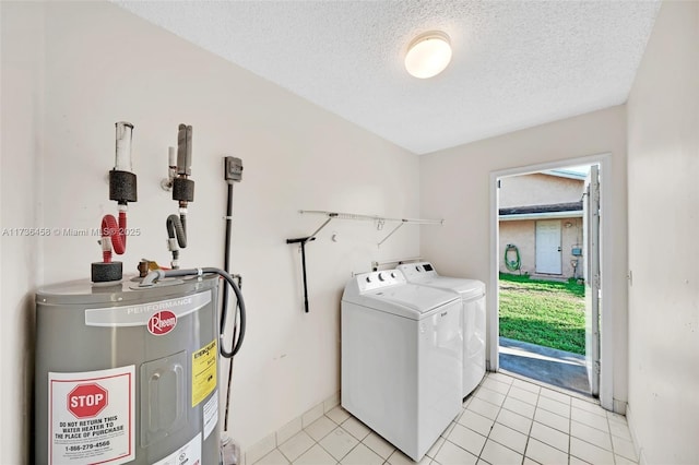 washroom featuring water heater, light tile patterned floors, a textured ceiling, and independent washer and dryer