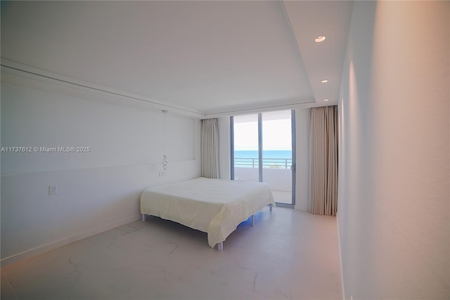 bedroom featuring a water view and concrete floors