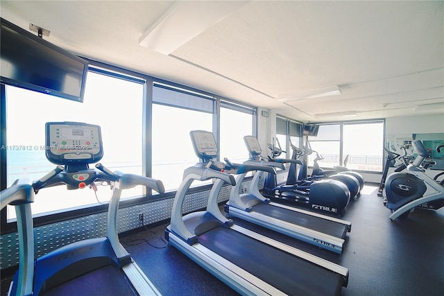 gym with a wall of windows