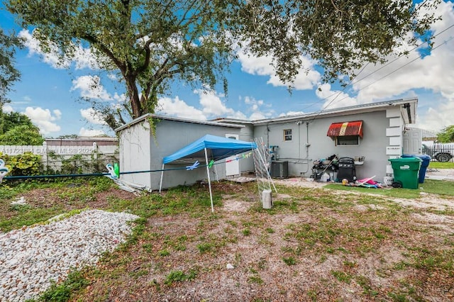 back of house featuring central AC unit