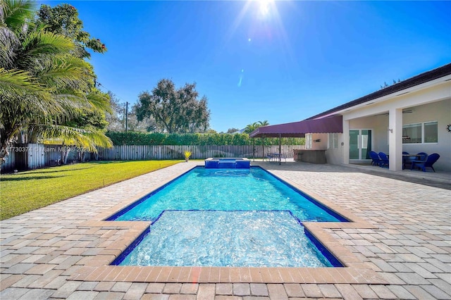 view of pool with a patio, a fenced backyard, and a pool with connected hot tub