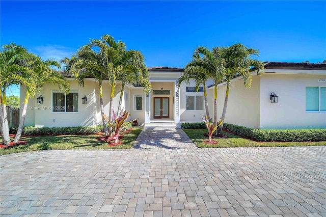 view of front of home with french doors and stucco siding
