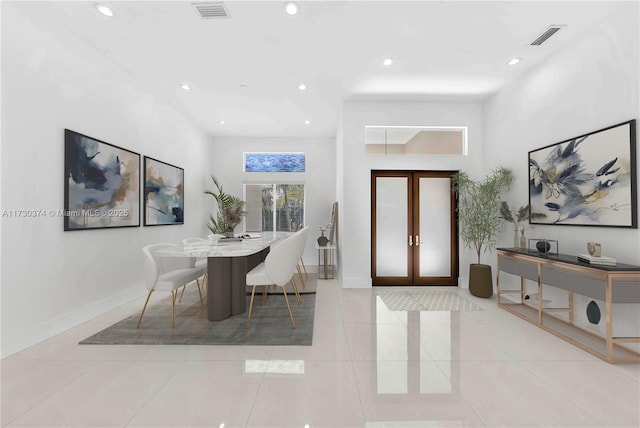 tiled dining space featuring french doors and recessed lighting