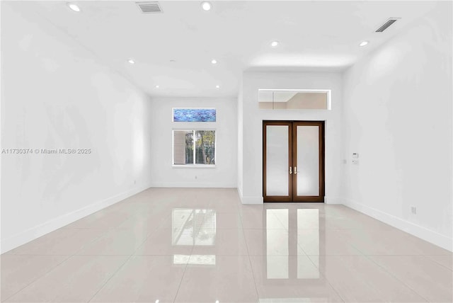 foyer featuring light tile patterned floors, french doors, and recessed lighting