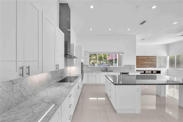 kitchen featuring stone counters, black electric stovetop, backsplash, recessed lighting, and white cabinets