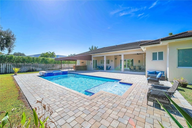 view of pool with a fenced backyard, a patio, a ceiling fan, and a pool with connected hot tub