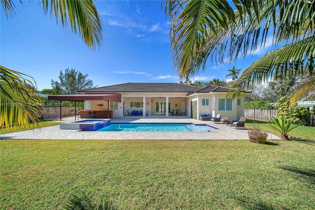 view of pool featuring a fenced backyard, a patio, and a pool with connected hot tub