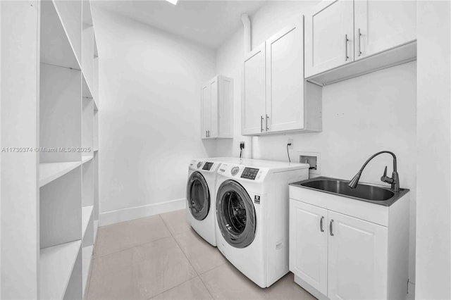 laundry room with cabinet space, washing machine and dryer, and light tile patterned floors