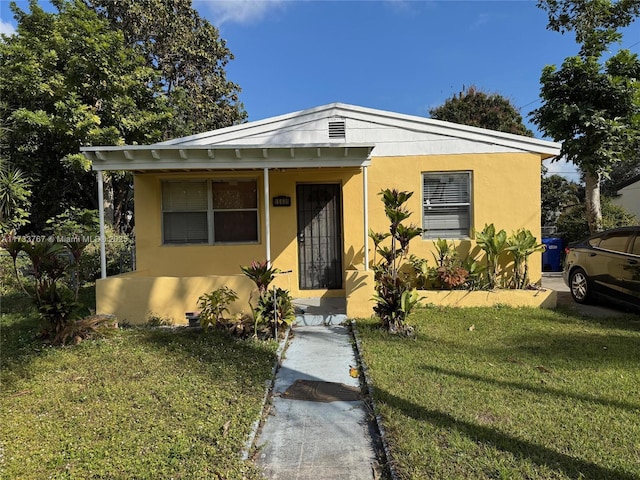 bungalow-style home featuring a front yard