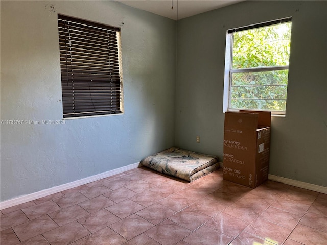 spare room with light tile patterned floors