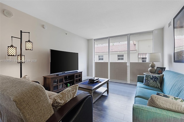 living area featuring wood finished floors and floor to ceiling windows