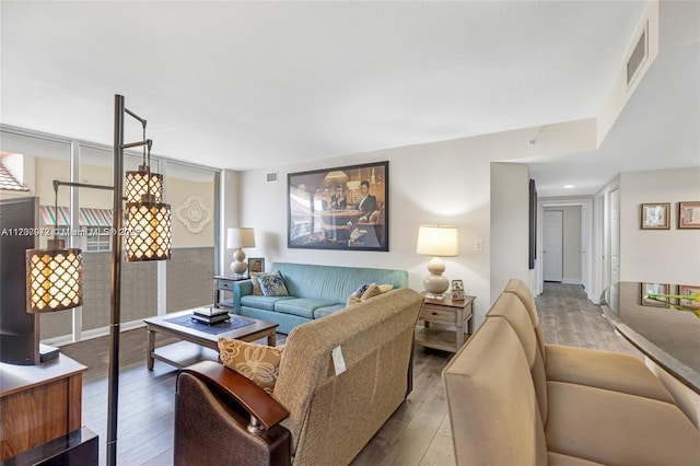 living area with visible vents and light wood finished floors