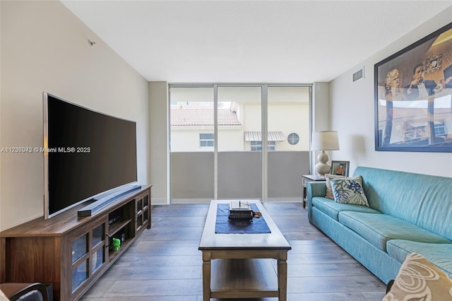 living room featuring visible vents and wood finished floors