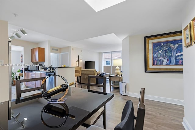 interior space with visible vents, light wood-style flooring, and baseboards