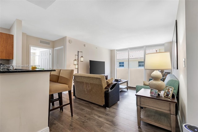 living room with visible vents and dark wood-style flooring