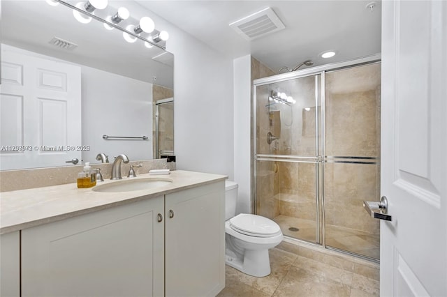 bathroom featuring a stall shower, visible vents, and toilet