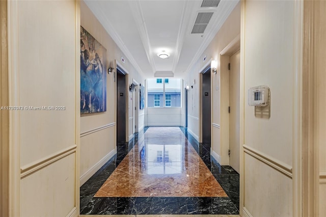 corridor featuring marble finish floor, visible vents, ornamental molding, and baseboards