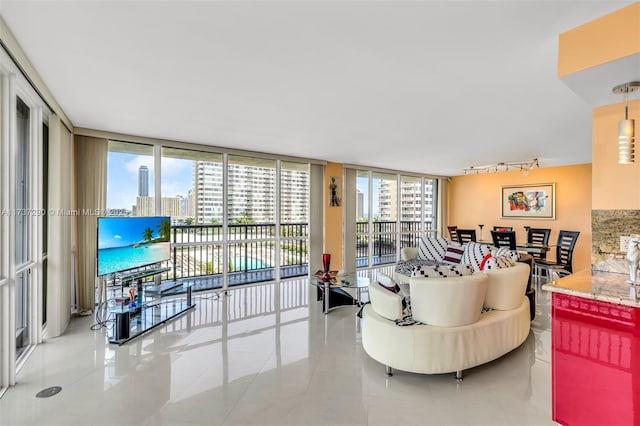 tiled living room with floor to ceiling windows and track lighting