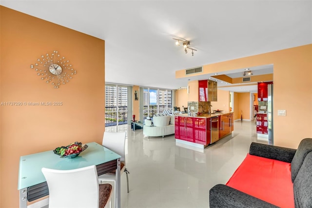 tiled living room featuring floor to ceiling windows