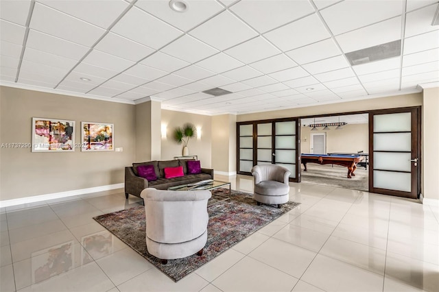 living room featuring tile patterned flooring, crown molding, a paneled ceiling, and billiards