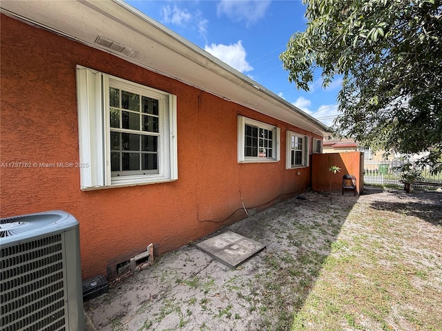 view of side of property with central AC