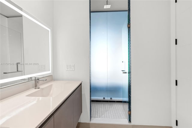 bathroom with tile patterned floors, vanity, and a shower with shower door