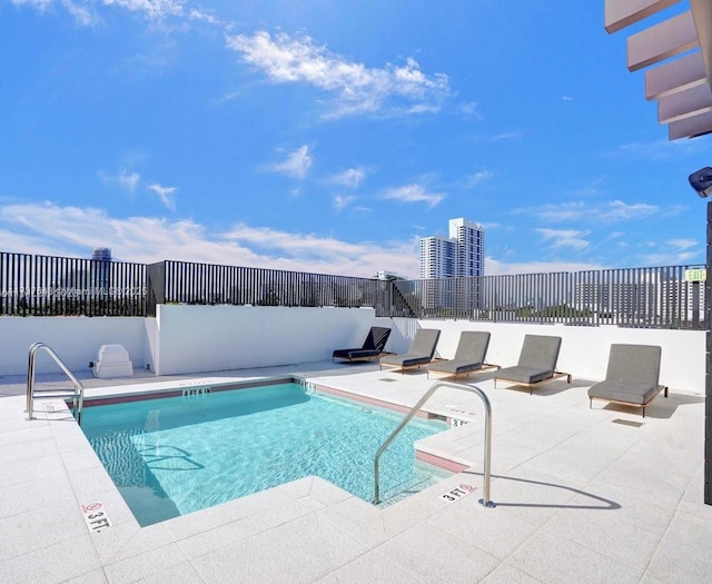 view of swimming pool featuring a patio area