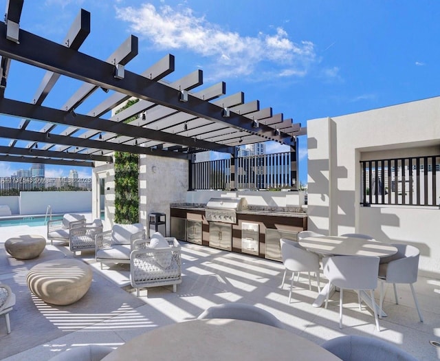 view of patio / terrace with a grill, a pergola, and exterior kitchen