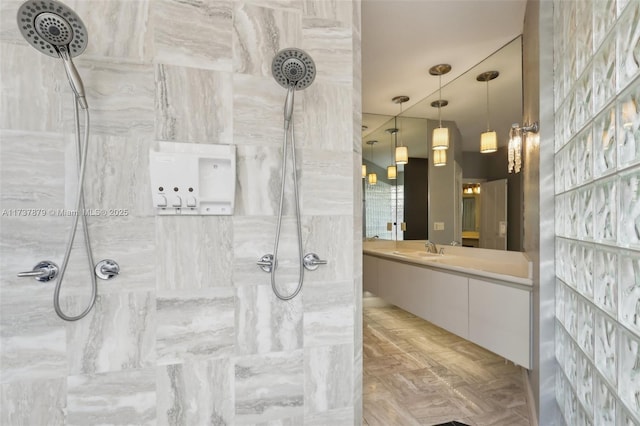 bathroom featuring vanity and a tile shower